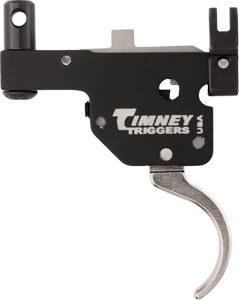 Timney Triggers firearm trigger mechanism with a curved silver trigger and black housing, shown from the side.