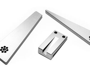 Set of three metal wedge tools with a small clamp on a white background.