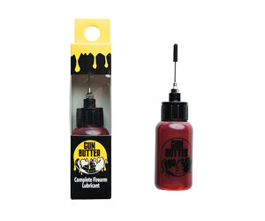 Red lubricant bottle with a long applicator beside its black-and-yellow box labeled 'Gun Butter' Complete Firearm Lubricant.