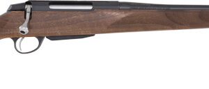 Bolt-action rifle with a wooden stock and long barrel photographed from the side.