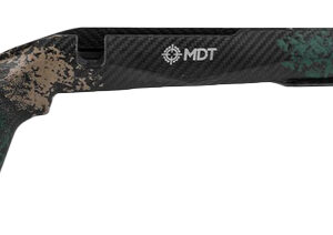 Camouflage-pattern MDT rifle stock with adjustable cheek rest and long forend, laid horizontally.