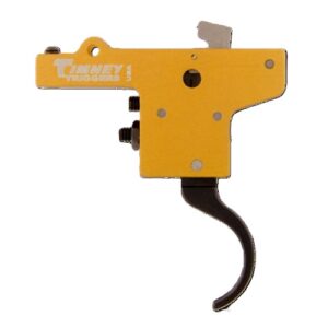 Yellow Timney Triggers rifle trigger assembly with curved black trigger and metallic mounting pieces visible.