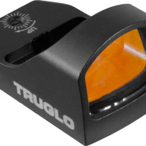 Compact black TAUGLO red dot sight with orange-tinted lens and adjustment dials, shown from the side about to mount on a rail surface.