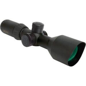 Black riflescope with three adjustment turrets and a green-tinted objective lens, mounted for aiming on a rifle