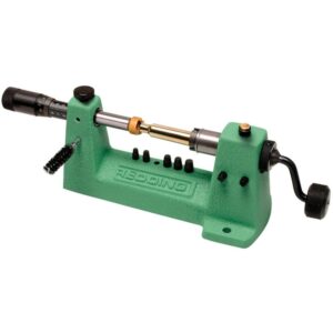 Green mini benchtop lathe with a brass rod between centers and a right-side hand crank for turning parts.