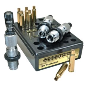 Redding premium die set for .308 Winchester on a black storage box, with brass cases and dies nearby