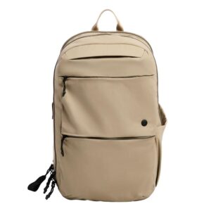 Beige backpack with two front zip pockets, a side pocket, and a top carry handle.